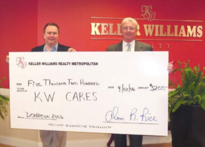 Keller Williams Realty Metropolitan. Two men holding a giant check for 5,200 dollars paid to KW Cares.