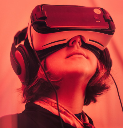 A portrait view of a young person wearing a virtual reality headset.