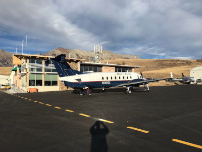Telluride Regional Airport Terminal with an older style prop plane out front.